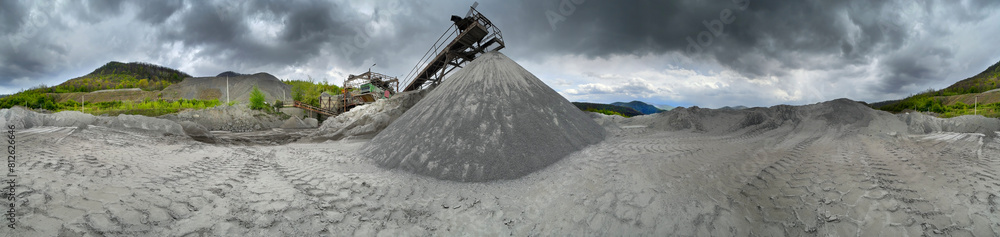 Carpathian Mountains of Ukraine, a quarry where granite sandstone is mined for the production of building materials, powerful trucks and conveyors load gravel - video from a drone