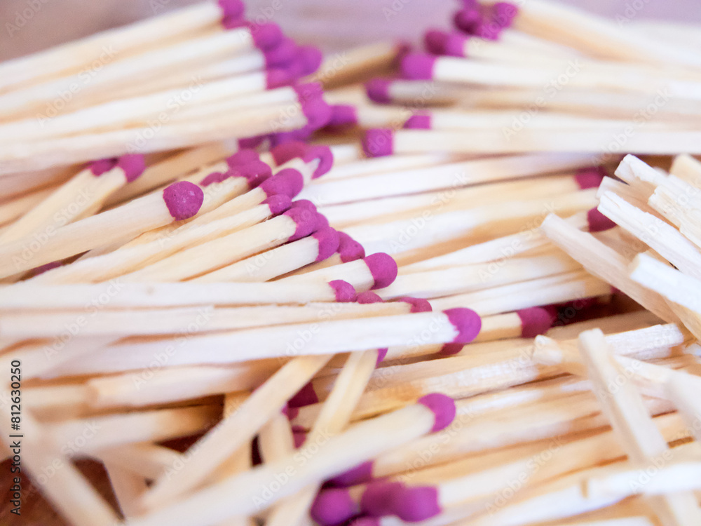 Colorful Matchstick Heads. A cluster of matchsticks with purple heads. Uses for Safety instructions, educational content.