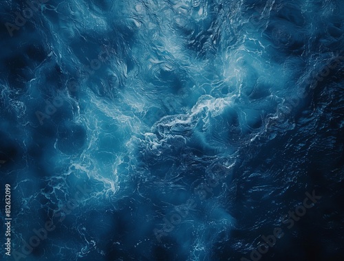 This image depicts an intricate dark blue textured pattern  reminiscent of the churning deep ocean or ripples on water