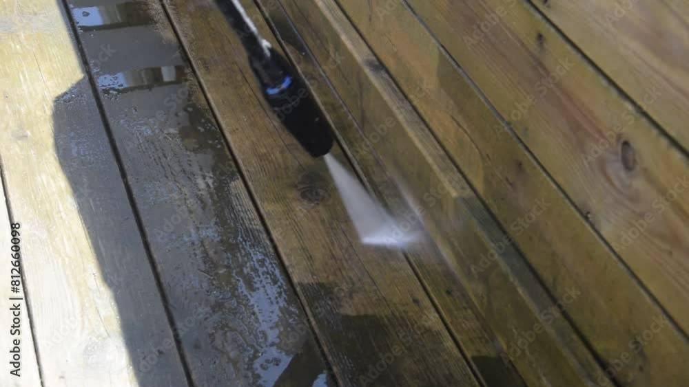 High pressure washer for cleaning wooden deck boards outside High pressure washer for cleaning wooden deck boards outside