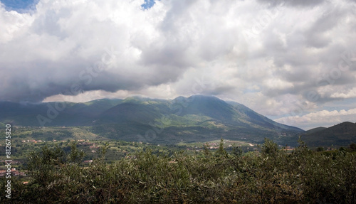 Cloudy sky over Olive tree grove with valley and Taburno-Camposauro mountain massif in the background. Sant’Agata dei Goti in the province of Benevento, Italy. photo