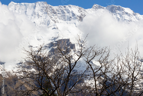 Alpine mountains in Switzerland. Snowy peak against the blue sky. Tourist resort. Nature in Europe