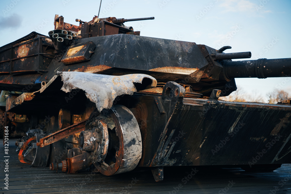 Damaged wheel tracks of destroyed and burned out tank on on the city street due to war of Russia and Ukraine Damaged wheel tracks of destroyed and burned out tank on on the city street due to war of Russia and Ukraine