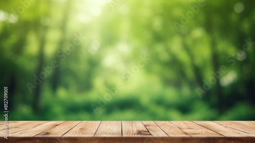 A Wooden table space with green background  blurred back view .