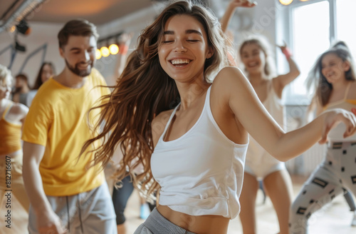 happy people dancing in the dance studio, one man and woman couple is wearing white tshirt and yellow pants, they look at each other with love smile and enjoying their time together © Kien