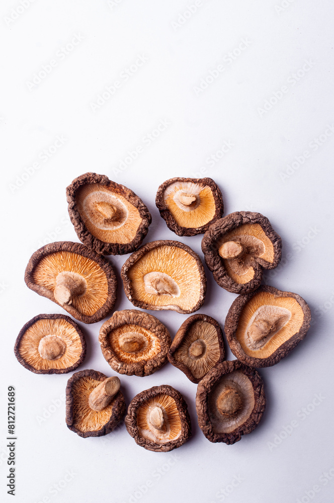 Dried shiitake mushrooms on white background flat lay copy space japanese cuisine Dried shiitake mushrooms on white background flat lay copy space japanese cuisine