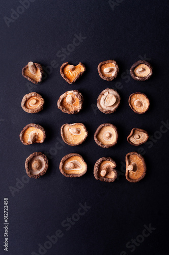 Dried shiitake mushrooms on black background flat lay food ingredient japanese cuisine copy space