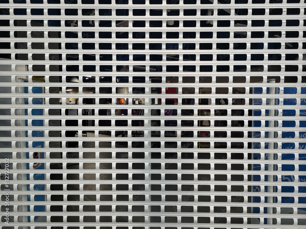 Grey metal mesh curtain door entrance to the store. Grey metal mesh curtain door entrance to the store.