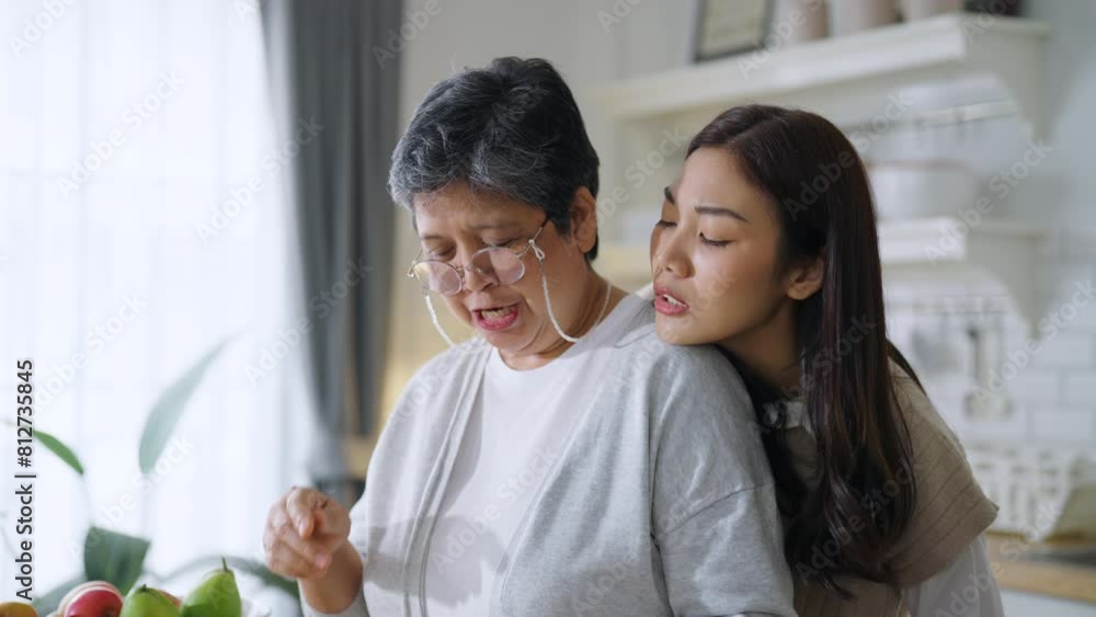 Asian mother and daughter share a beautiful moment of connection in the morning talking together in morning and prepare breakfast moment of bonding in the kitchen area of their home. Asian mother and daughter share a beautiful moment of connection in the morning talking together in morning and prepare breakfast moment of bonding in the kitchen area of their home.
