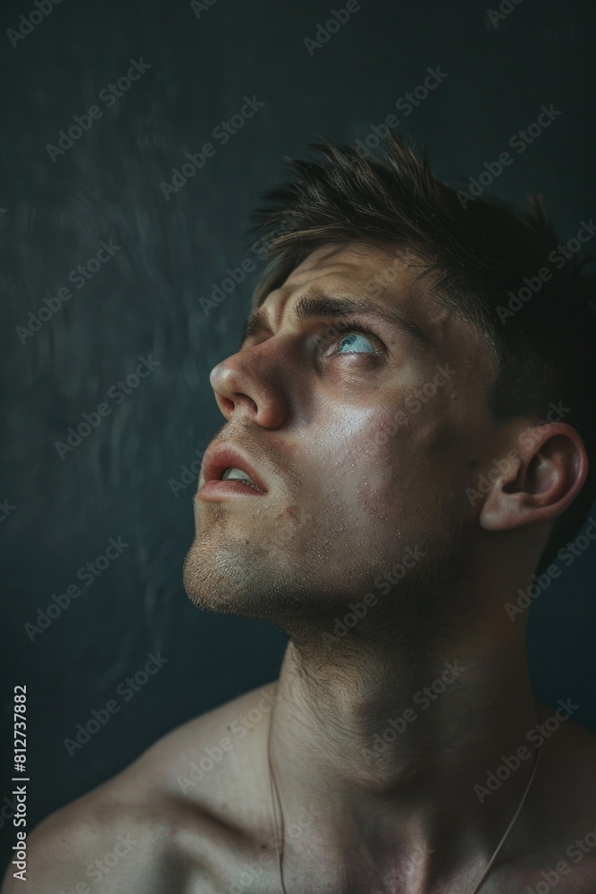 A shirtless man gazing up at the sky. Suitable for various concepts and designs A shirtless man gazing up at the sky. Suitable for various concepts and designs