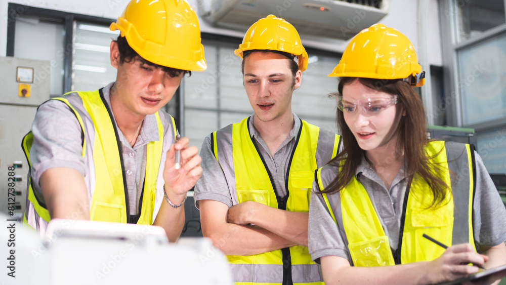 A Group of engineer are examining machine robot arm with smart tablet. Installation indoor industrial factory. Technician coworker check for repair maintenance electronic operation with remote system A Group of engineer are examining machine robot arm with smart tablet. Installation indoor industrial factory. Technician coworker check for repair maintenance electronic operation with remote system