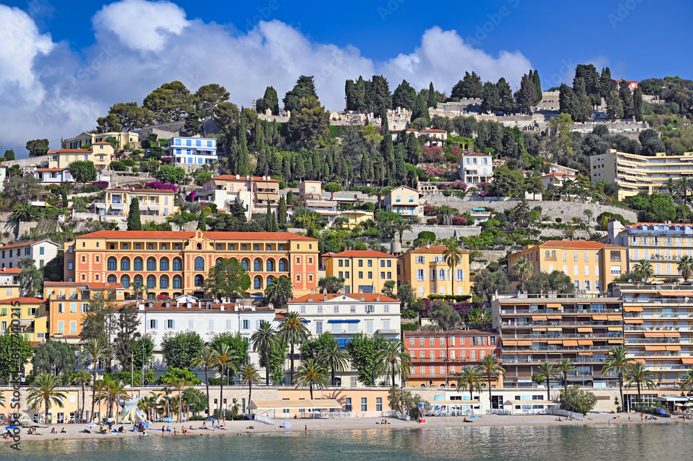 Beach and hills with old buildings in Menton France Beach and hills with old buildings in Menton France