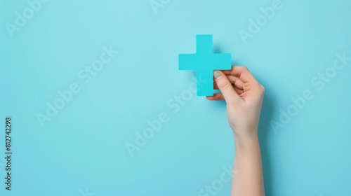 Hand Holding Blue Medical Cross