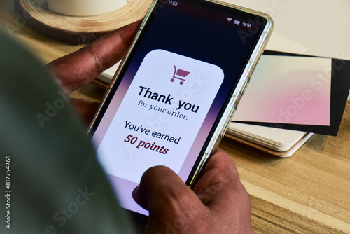 Customer loyalty program concept for digital marketing strategy. Man earned points shopping online using the mobile application.