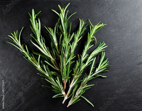 composition of rosemary sprigs on a black background