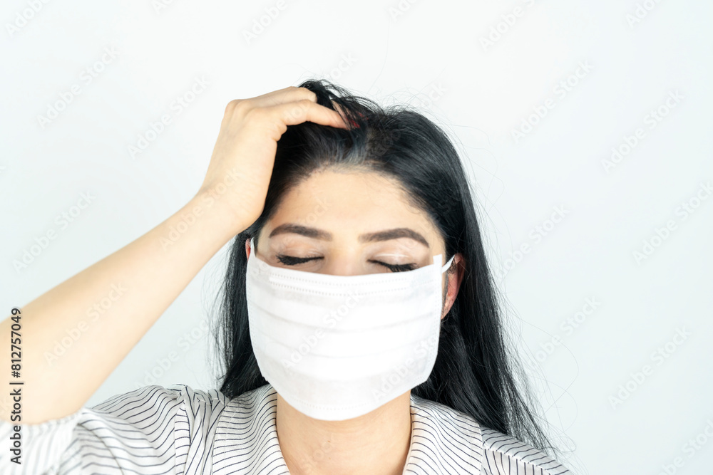 Young woman with surgical mask on face against SARS-CoV-2. COVID-19 Pandemic Coronavirus Young girl in white room wearing face mask Young woman with surgical mask on face against SARS-CoV-2. COVID-19 Pandemic Coronavirus Young girl in white room wearing face mask