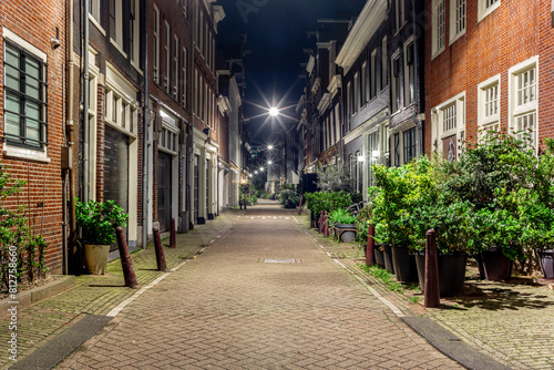 A typical cobbled stone lane in Amsterdam late at night with traditional architecture in the old town