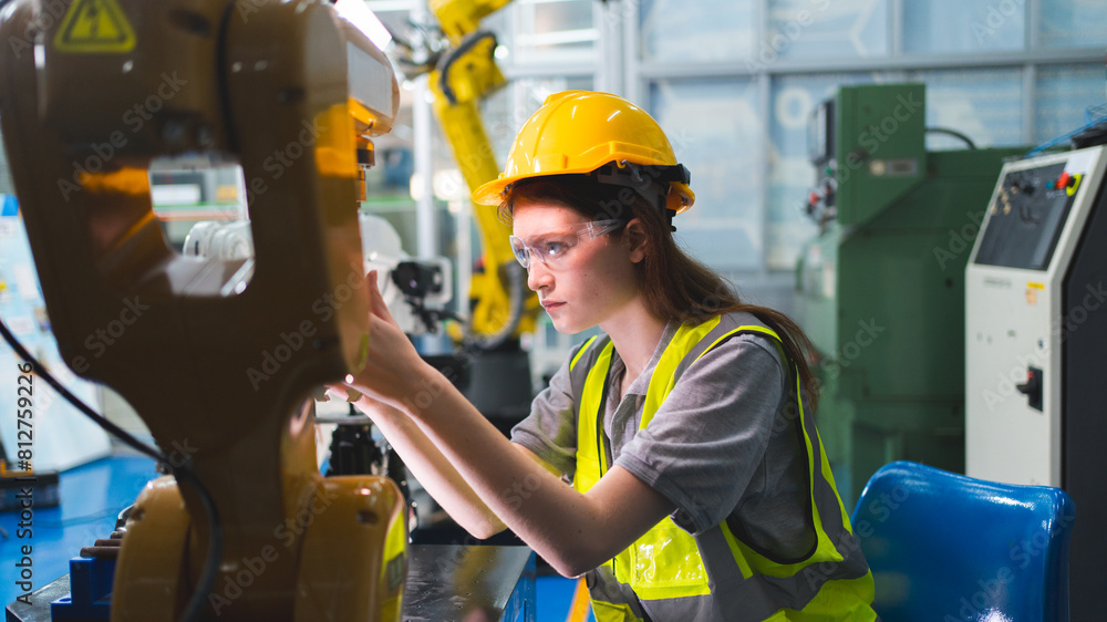 Professional and intelligence female engineer used her technical hard skill to fix, repair or maintenance machine robotic arm in factory or industrial, examining or welding automobile machine workshop Professional and intelligence female engineer used her technical hard skill to fix, repair or maintenance machine robotic arm in factory or industrial, examining or welding automobile machine workshop
