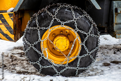 Close-up of the snow chain on the tire of a bulldozer