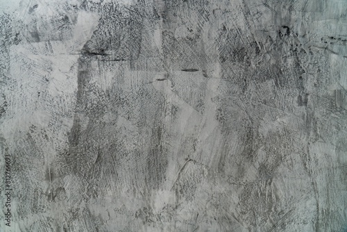 A close up of a grey concrete wall with a rough texture.