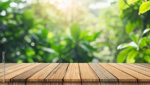 empty wood table top on blur abstract green garden from window kitchen in the morning