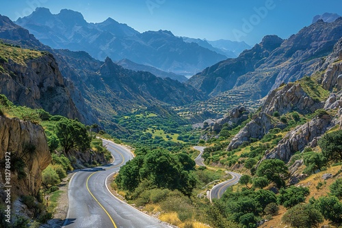 A road that winds through the mountains, with a valley in the background © Nam