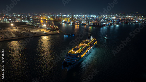 luxury cruise ship for first class passenger is sailing out of the port, motion effect low shutter speed to want movement of the cruise ship, night scene shipping port,