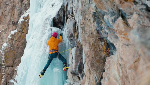 Ice climbing at frozen waterfall. photo