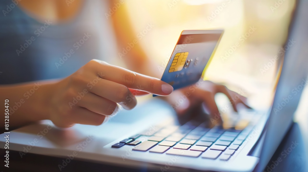 A person using a credit card to make an online purchase. A person using a credit card to make an online purchase.