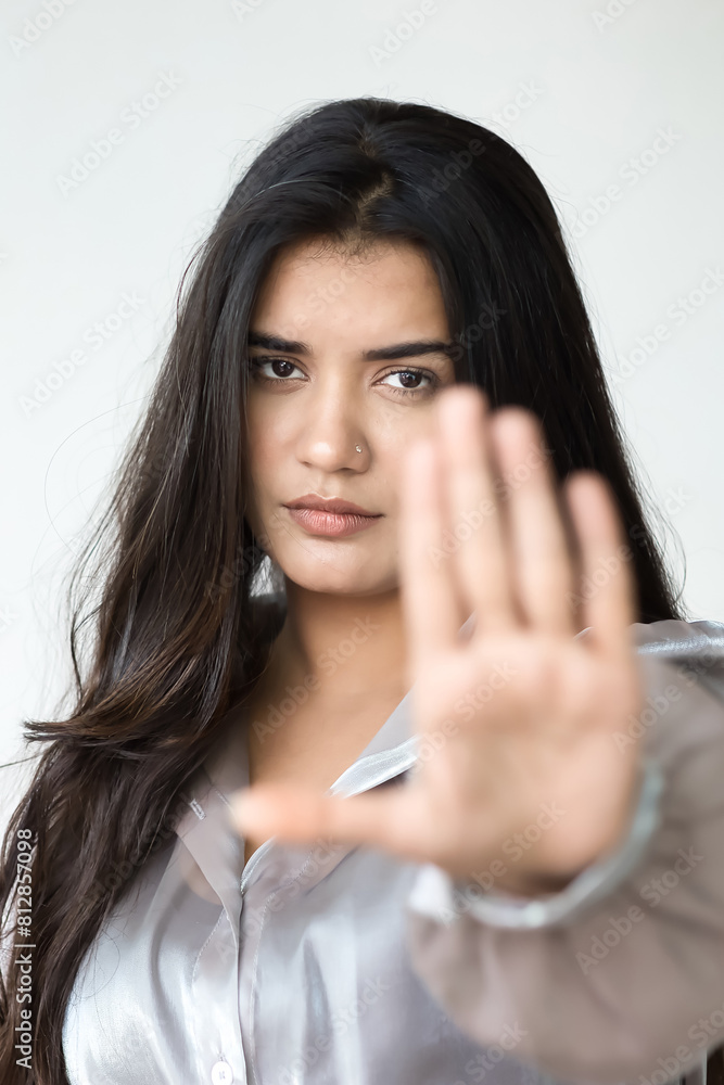 Halt, Stop it, no way, Indian Woman Expressing Refusal, showing Rejecting Stop Hand Sign to Communicate Prohibition and Rejection on isolated background Halt, Stop it, no way, Indian Woman Expressing Refusal, showing Rejecting Stop Hand Sign to Communicate Prohibition and Rejection on isolated background