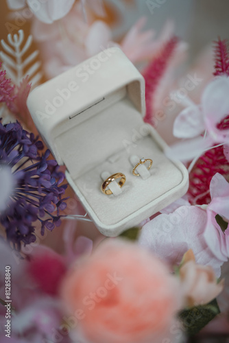 wedding rings in a box on a bouquet