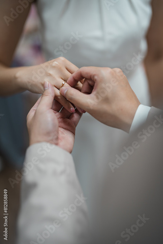 bride and groom holding hands with engagement diamond ring on the bride hand.	

