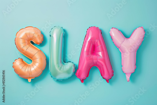 orange and pink,blue  "slay" balloon letters on mint background for energetic and vibrant party themes