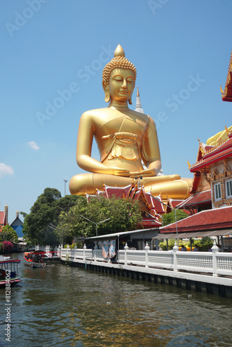 Big Golden Buddha Statue in Wat Pak Nam Phasi Charoen or Pak Nam Temple - It is famous for its large seated Buddha that is the largest in Bangkok Thailand - Travel Sculpture and Architecture Religion 