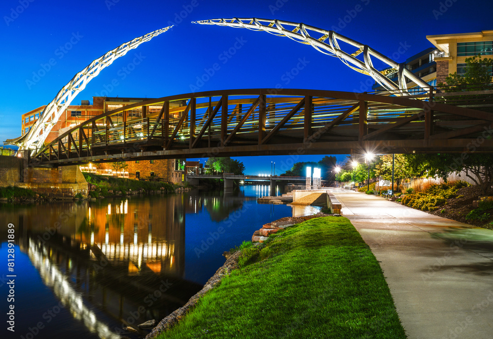 Sioux Falls Downtown River Greenway Lighted Trail, Skyline, Bridges, and Reflectoins on the Big Sioux River Water at Night in South Dakota, USA