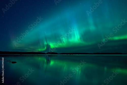 Northern lights dancing over calm lake in north of Sweden. Farnebofjarden national park.