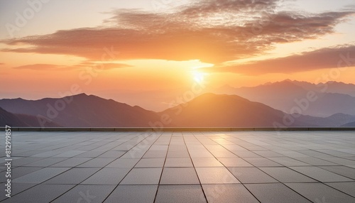 A wide flat roof top with a background of sunset and mountains