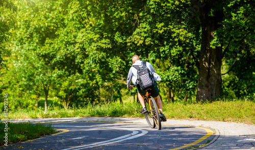 Wallpaper Mural Cyclist ride on the bike path in the city Park Torontodigital.ca