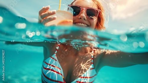 Summer lifestyle portrait of young stunning blonde girl Enjoying life smiling drinking cocktail in the turquoise sea Wearing stylish sunglasses stripes swimsuit Half over half under wa : Generative AI photo