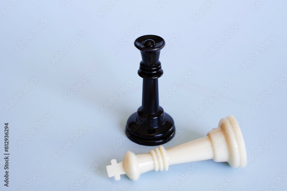 standing queen and defeated king chess pieces. feminism concept standing queen and defeated king chess pieces. feminism concept