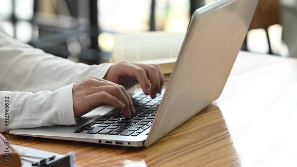 Slow motion shot female college student typing on laptop for searching information on internet