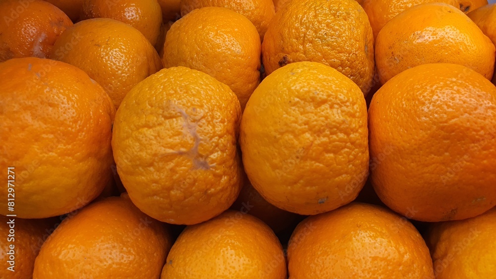 Close up pile of tasty fresh oranges sold at the market as a background. Close up pile of tasty fresh oranges sold at the market as a background.