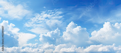 Vast blue sky with clouds as a background providing ample copy space image photo