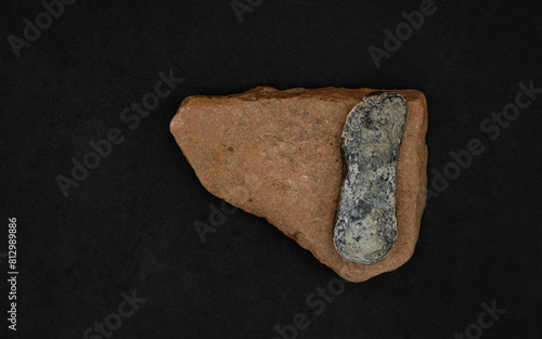 Stone Age knife. Primitive stone tool early Stone Age on a stone surface. Copy space.