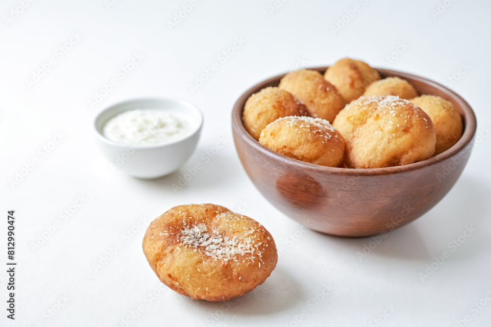 Golden Fried Dough Balls Sprinkled with Sugar, Served with a Creamy Dip Golden Fried Dough Balls Sprinkled with Sugar, Served with a Creamy Dip