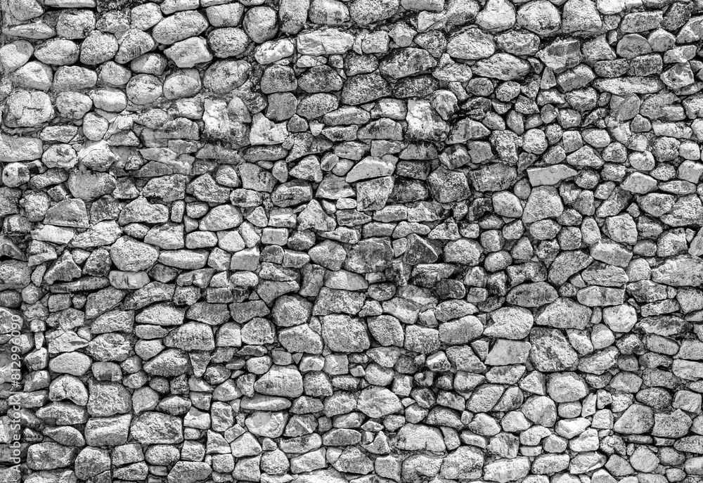 Small stone wall texture for background. Part of a stone wall or pebbles wall, for background or texture in black and white Small stone wall texture for background. Part of a stone wall or pebbles wall, for background or texture in black and white