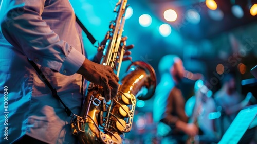 A musician playing the saxophone with the band on stage