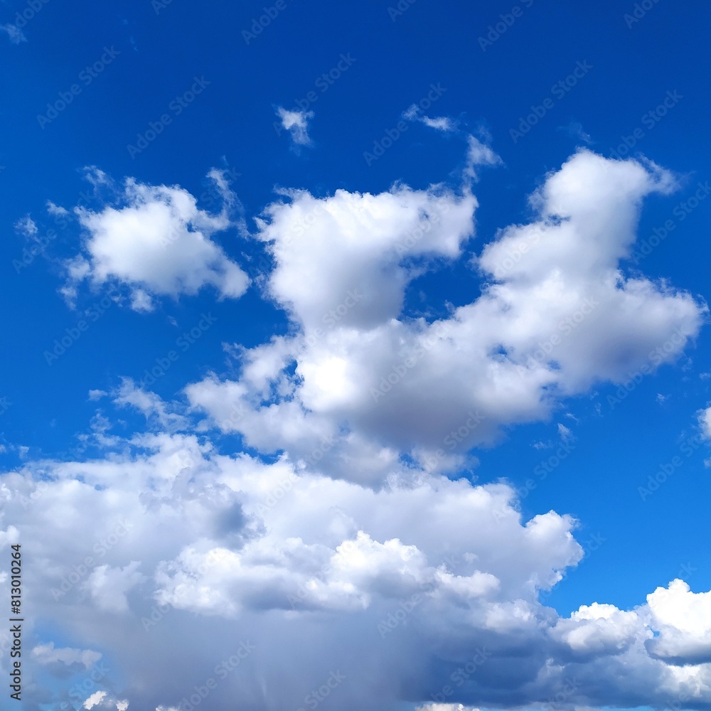 Fototapeta premium Blue sky background with white clouds. Cumulus white clouds in the blue sky.