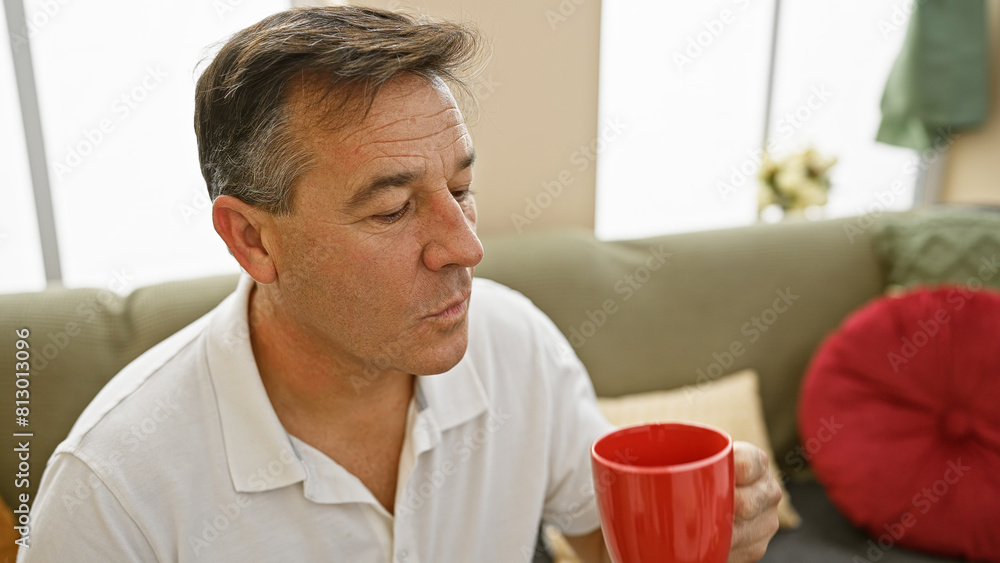 A pensive middle-aged man holding a mug in a cozy living room setting, exuding a sense of relaxation and contemplation. A pensive middle-aged man holding a mug in a cozy living room setting, exuding a sense of relaxation and contemplation.