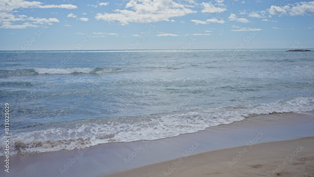 Serene beachscape with clear skies, gentle waves, and an inviting sandy shore under bright daylight. Serene beachscape with clear skies, gentle waves, and an inviting sandy shore under bright daylight.